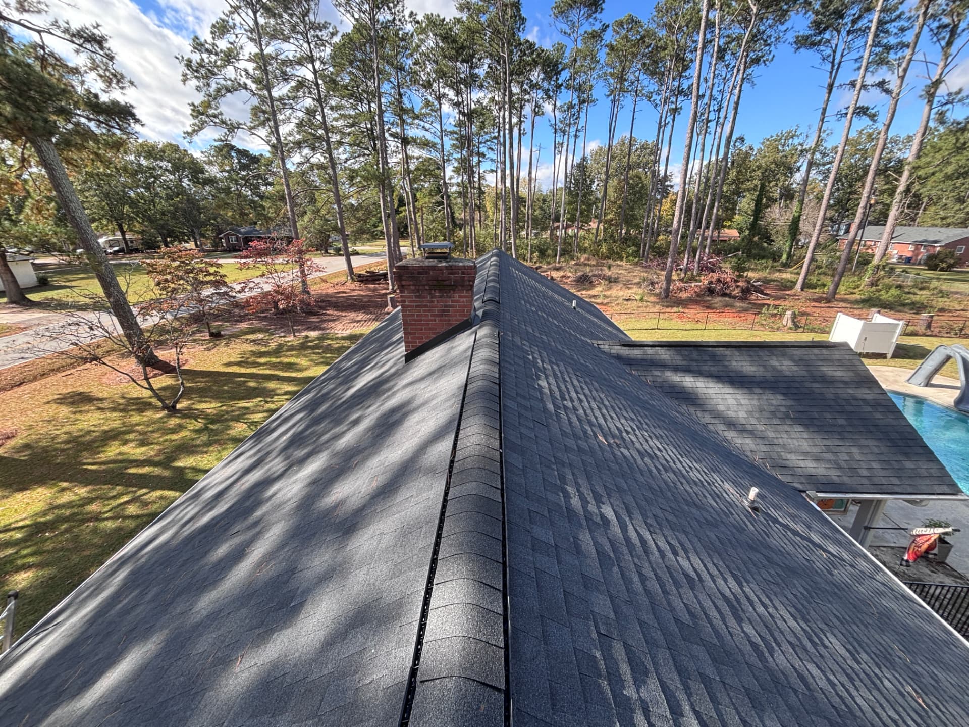 New charcoal architectural shingle roof over a backyard pool on a Greenwood SC home by Coster Roofing Co