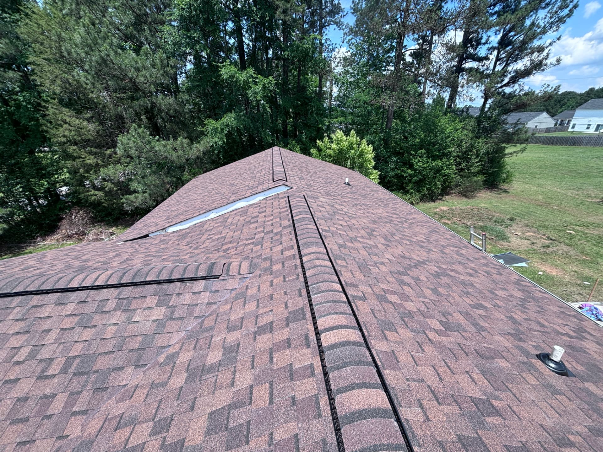 New brown architectural shingle roof with ridge vent installed by Coster Roofing Co in Greenwood SC