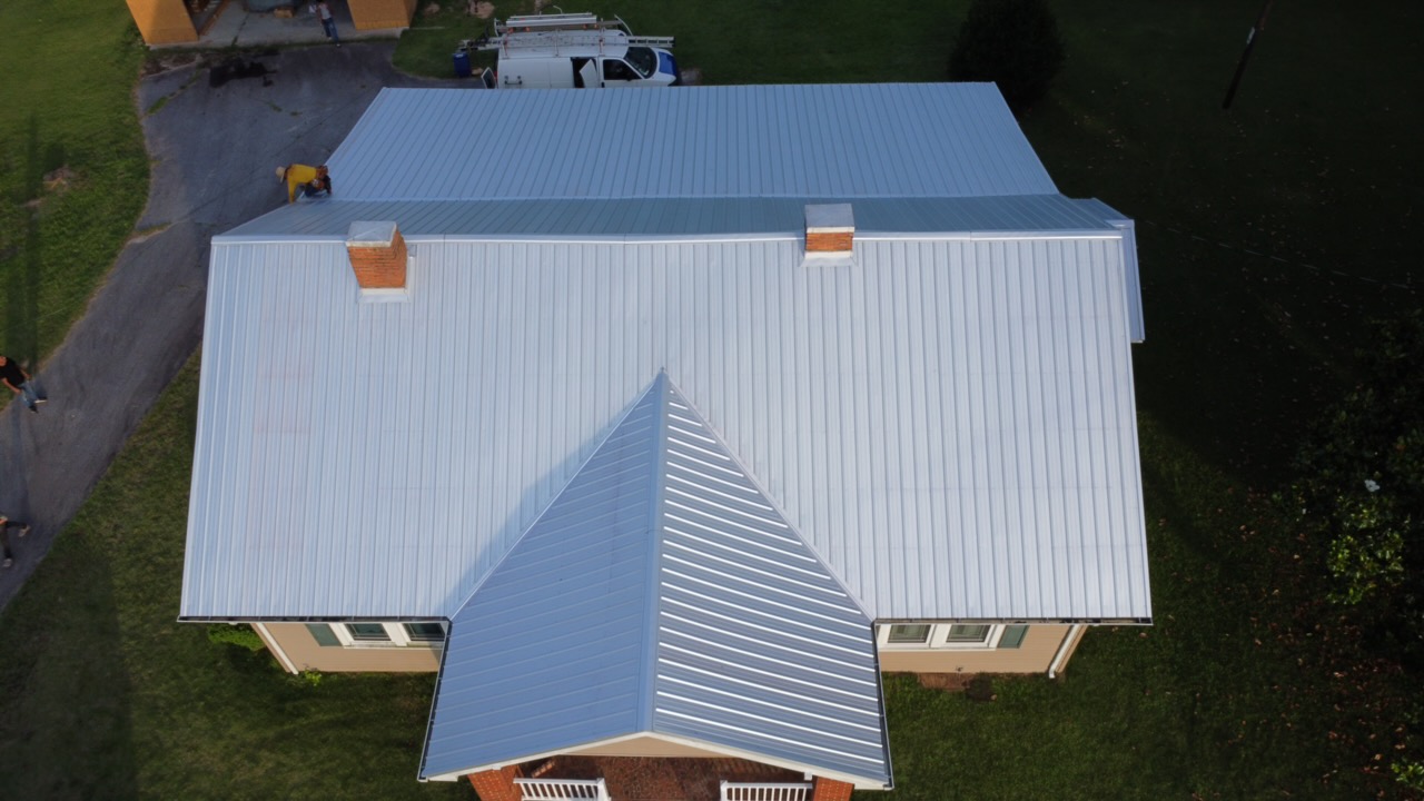 Aerial drone view of a completed metal roof replacement by Coster Roofing Co in South Carolina