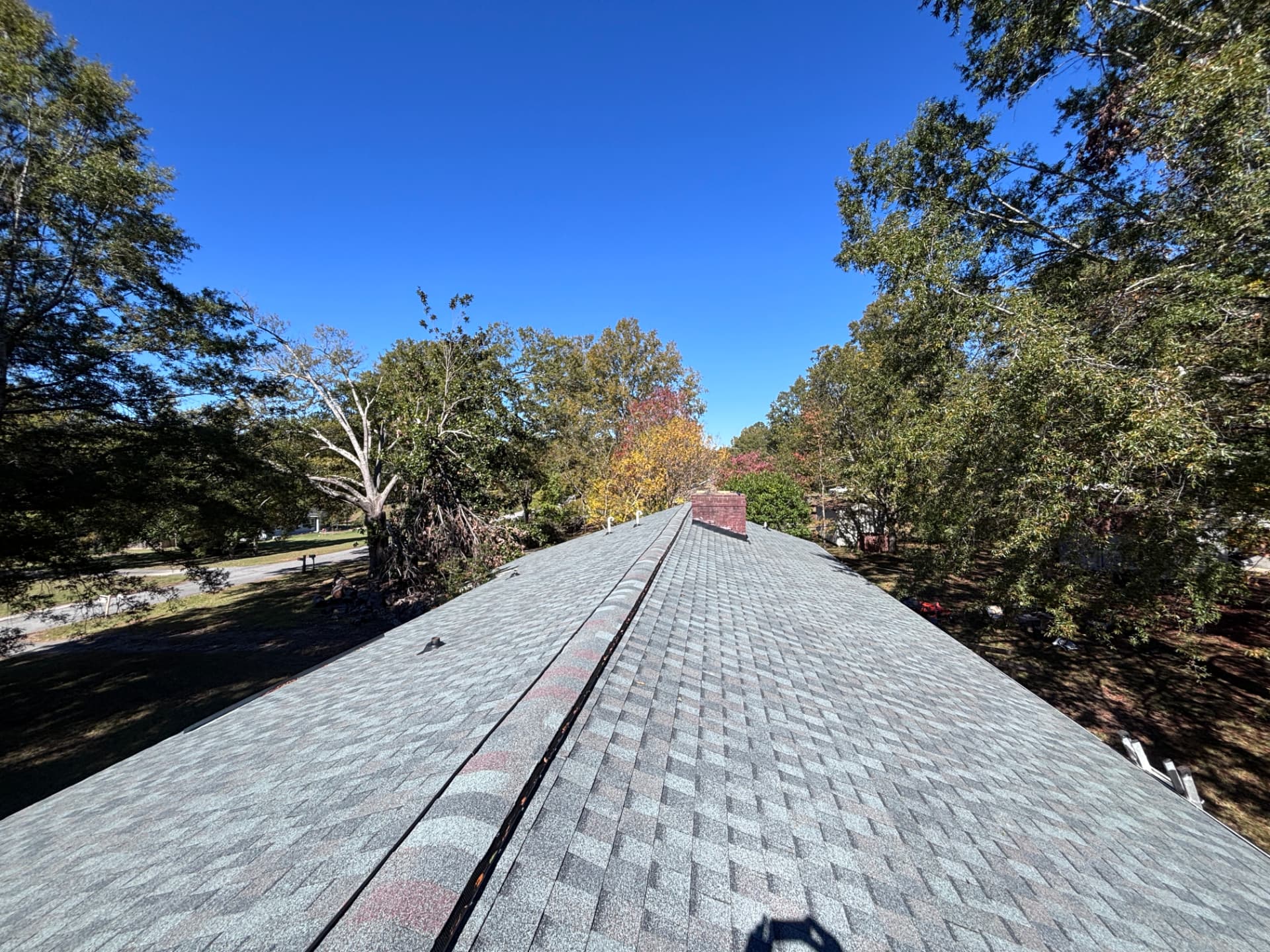 Long ridge line of a new slate gray architectural shingle roof installed by Coster Roofing Co in Abbeville SC