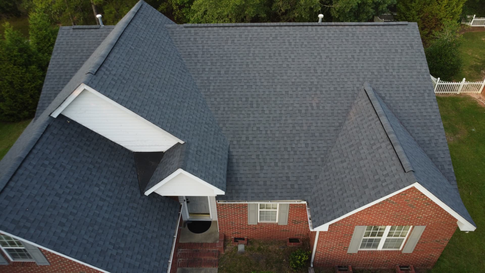 Brick home with a new charcoal architectural shingle roof in Cross Hill SC by Coster Roofing Co