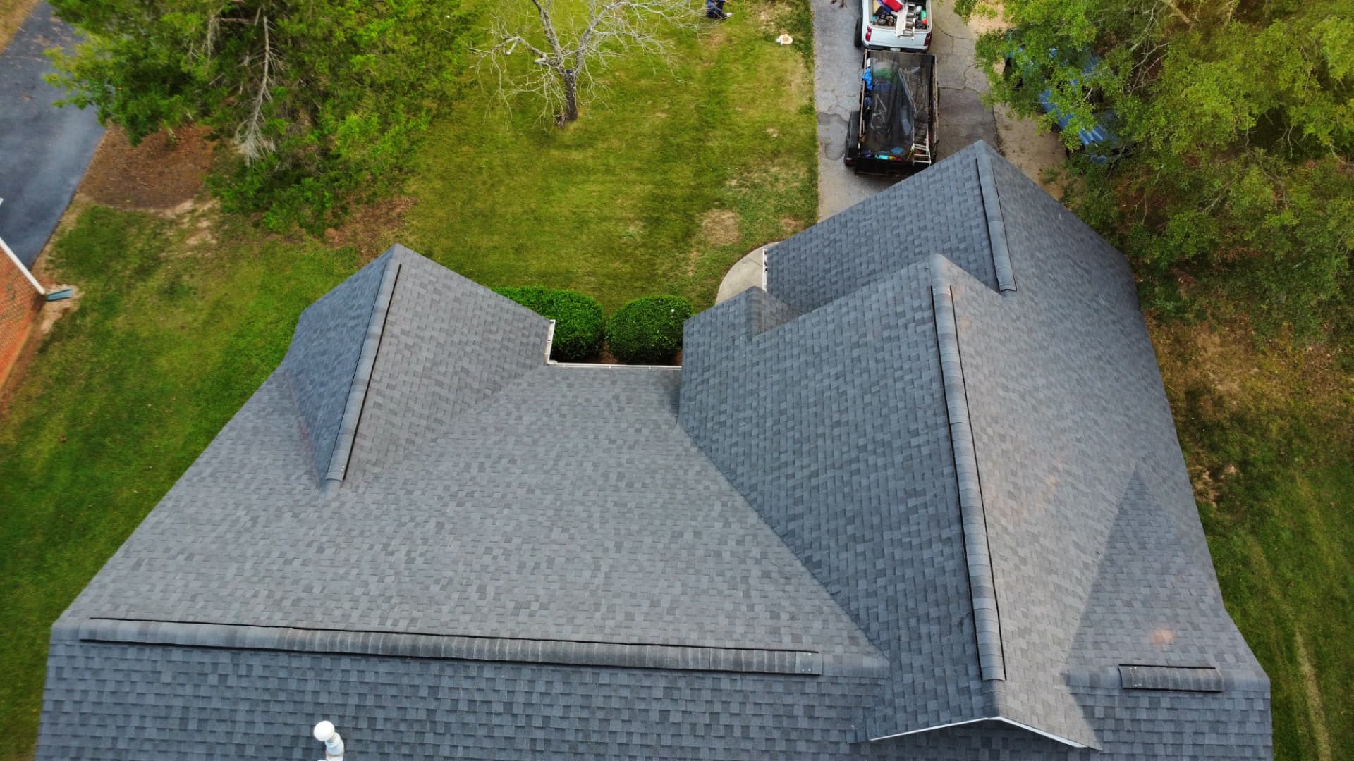 Overhead drone view of a finished gray architectural shingle roof in Newberry SC by Coster Roofing Co